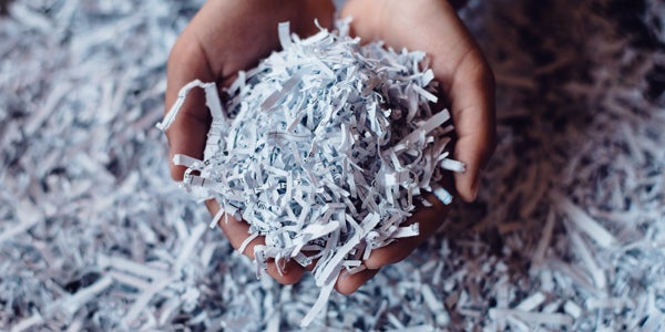 Cupped hands holding shredded paper