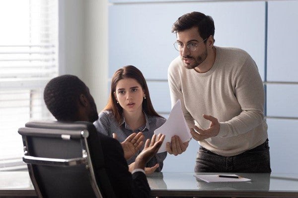 Angry couple talking to advisor about a phishing scam