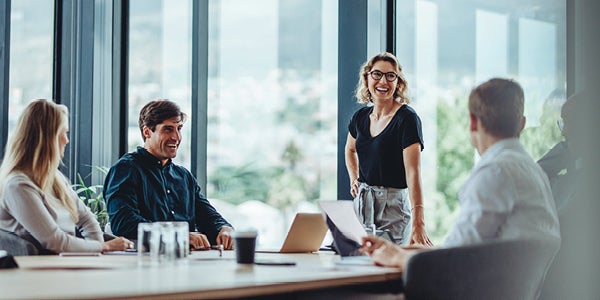 Coworkers laughing during a team meeting