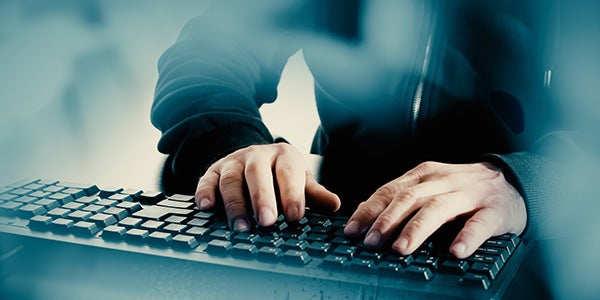 man on keyboard looking at fraud prevention