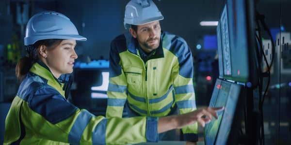 Technicians working together on a computer